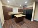 This kitchen is equipped with a kitchen island, wooden cabinets, and stainless steel appliances at 10537 Thor Mountain Ln, Las Vegas, NV 89166