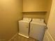 Practical laundry room equipped with a washer, dryer, and a convenient storage shelf at 10537 Thor Mountain Ln, Las Vegas, NV 89166
