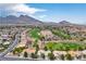 Stunning aerial view of a neighborhood with lush golf course and mountain backdrop, offering picturesque scenery at 10646 Heritage Hills Dr, Las Vegas, NV 89134