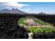 Aerial view of a golf course with mountains in the background, located near residential homes at 10646 Heritage Hills Dr, Las Vegas, NV 89134