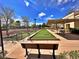 Outdoor bocce ball court with covered seating areas and lush landscaping under a sunny sky at 10646 Heritage Hills Dr, Las Vegas, NV 89134