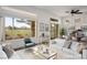 Bright, virtually staged living room with large windows offering golf course views and contemporary furnishings at 10646 Heritage Hills Dr, Las Vegas, NV 89134
