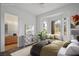 Bright staged bedroom featuring bay windows with bench, view, neutral decor, and connecting ensuite bathroom at 10646 Heritage Hills Dr, Las Vegas, NV 89134