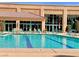 Outdoor pool with swimming lanes, lounge chairs, and a view of the clubhouse at 10646 Heritage Hills Dr, Las Vegas, NV 89134