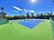 Bright blue tennis court with new green surface ready for a tennis match on a clear, sunny day at 10646 Heritage Hills Dr, Las Vegas, NV 89134