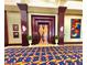 Elegant theater entrance with decorative columns, artwork, and geometric patterned carpet at 10646 Heritage Hills Dr, Las Vegas, NV 89134