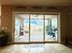 View of covered patio through living room sliding glass doors at 10719 Hammett Park Ave, Las Vegas, NV 89166