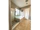 Bright bathroom featuring a glass shower and soaking tub with natural light from window at 10719 Hammett Park Ave, Las Vegas, NV 89166