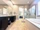 Bathroom featuring a double vanity, soaking tub, and glass-enclosed shower at 10719 Hammett Park Ave, Las Vegas, NV 89166