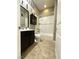 This bathroom features a vanity with a dark wood cabinet and a shower-tub combo at 10719 Hammett Park Ave, Las Vegas, NV 89166
