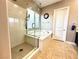 Bathroom showcasing a soaking tub and glass-enclosed shower with tile flooring at 10719 Hammett Park Ave, Las Vegas, NV 89166
