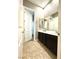 Bathroom features dark wood vanity and shower and bath combo at 10719 Hammett Park Ave, Las Vegas, NV 89166
