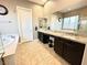 A bathroom featuring a double vanity, soaking tub, and bright neutral tones at 10719 Hammett Park Ave, Las Vegas, NV 89166