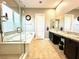 Bright bathroom with a double sink vanity, soaking tub, and walk-in shower at 10719 Hammett Park Ave, Las Vegas, NV 89166