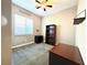 Bedroom featuring carpeted floors, a ceiling fan, and a large window with natural light at 10719 Hammett Park Ave, Las Vegas, NV 89166
