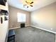 Cozy carpeted bedroom with a ceiling fan, natural light, and neutral wall color at 10719 Hammett Park Ave, Las Vegas, NV 89166