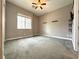 Bright, carpeted bedroom with neutral walls, a ceiling fan, and shelving at 10719 Hammett Park Ave, Las Vegas, NV 89166
