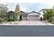 Charming single-story home with a well-manicured lawn and a three-car garage in a quiet neighborhood at 10719 Hammett Park Ave, Las Vegas, NV 89166