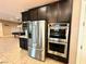 Updated kitchen showcasing stainless steel appliances, and dark wood cabinetry at 10719 Hammett Park Ave, Las Vegas, NV 89166