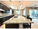 Elegant kitchen with granite countertops, pendant lighting, and seamless flow to the outdoors at 10719 Hammett Park Ave, Las Vegas, NV 89166