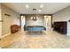 Large living room features tile flooring and an accent wall to showcase the piano at 10719 Hammett Park Ave, Las Vegas, NV 89166