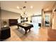 Open-concept living room with a pool table, piano, and tile flooring throughout at 10719 Hammett Park Ave, Las Vegas, NV 89166