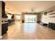 Living area with tile flooring, backyard access, and modern shelving at 10719 Hammett Park Ave, Las Vegas, NV 89166