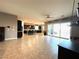 Open-concept living area with a kitchen bar and access to a patio at 10719 Hammett Park Ave, Las Vegas, NV 89166