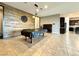 Bright open living room featuring natural wood wall and tile floors throughout at 10719 Hammett Park Ave, Las Vegas, NV 89166