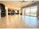 Open-concept living room featuring sliding glass doors and a ceiling fan at 10719 Hammett Park Ave, Las Vegas, NV 89166