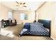 Main bedroom with a ceiling fan, large window, and carpet flooring creating a comfortable and bright space at 10719 Hammett Park Ave, Las Vegas, NV 89166