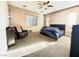 Spacious main bedroom featuring a ceiling fan, carpeted floors, and windows, offering a relaxing retreat at 10719 Hammett Park Ave, Las Vegas, NV 89166