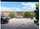 Outdoor patio featuring brick pavers, a rustic water feature, and comfortable seating under a bright, sunny sky at 10719 Hammett Park Ave, Las Vegas, NV 89166