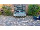 Close-up of the brick paver patio featuring a rustic water feature adorned with decorative elements and greenery at 10719 Hammett Park Ave, Las Vegas, NV 89166