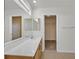 Bright bathroom features a large mirror, dual vanity, tile flooring and access to a walk-in closet at 1109 Claire Rose Ave, Las Vegas, NV 89183