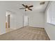 Spacious bedroom features a ceiling fan, carpet floor and multiple doors to the bathroom and hallway at 1109 Claire Rose Ave, Las Vegas, NV 89183