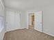 Bedroom with closet, carpet, neutral paint, and bright view to an adjoining laundry area at 1109 Claire Rose Ave, Las Vegas, NV 89183