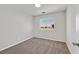 Bedroom featuring carpet flooring, white walls and a window with neighborhood views at 1109 Claire Rose Ave, Las Vegas, NV 89183