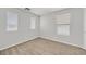 Carpeted bedroom with bright neutral paint, three windows with blinds, and baseboard trim at 1109 Claire Rose Ave, Las Vegas, NV 89183
