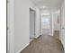 Hallway with carpet flooring provides access to bedrooms with windows at 1109 Claire Rose Ave, Las Vegas, NV 89183