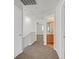 Bright hallway featuring neutral walls, carpet floors, and doorways to bedrooms and bathrooms at 1109 Claire Rose Ave, Las Vegas, NV 89183
