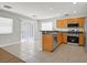 Open-concept kitchen features tile flooring, stainless steel appliances, and granite countertops at 1109 Claire Rose Ave, Las Vegas, NV 89183