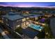 Aerial view of a modern home with a private pool, spa, and outdoor entertaining area at twilight at 12637 Penfield Ave, Las Vegas, NV 89138