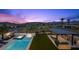 Aerial view of backyard featuring a pool, spa, outdoor kitchen and mountain views at 12637 Penfield Ave, Las Vegas, NV 89138
