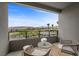 Balcony with outdoor seating, showcasing neighborhood views and desert landscape during daytime at 12637 Penfield Ave, Las Vegas, NV 89138