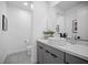 Modern bathroom featuring a white vessel sink, gray vanity, and neutral wall art at 12637 Penfield Ave, Las Vegas, NV 89138
