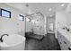 Modern bathroom featuring a freestanding tub, a walk-in shower, and sleek fixtures at 12637 Penfield Ave, Las Vegas, NV 89138
