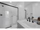 Modern bathroom featuring a sleek glass shower and contemporary vanity with matte black fixtures at 12637 Penfield Ave, Las Vegas, NV 89138