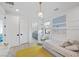 Cozy bedroom featuring stylish decor, ample natural light, and an ensuite bathroom at 12637 Penfield Ave, Las Vegas, NV 89138