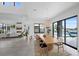 Open-concept dining area with a large wooden table, modern lighting, and views of the pool and backyard at 12637 Penfield Ave, Las Vegas, NV 89138